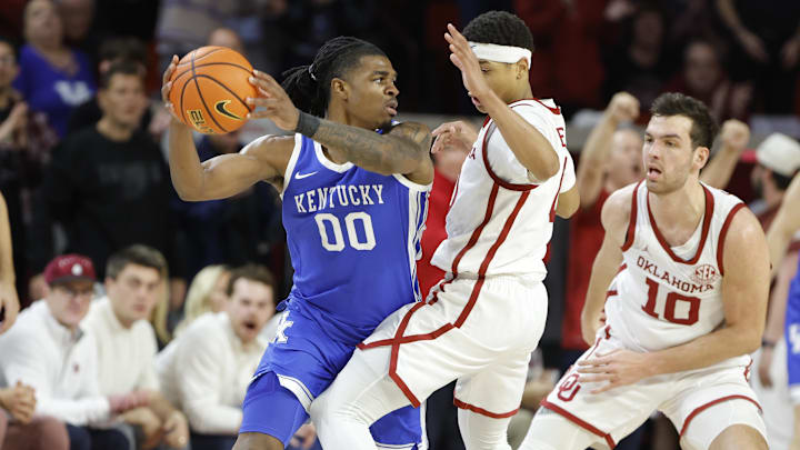 Feb 26, 2025; Norman, Oklahoma, USA; Oklahoma Sooners guard Jeremiah Fears (0) defends Kentucky Wildcats guard Otega Oweh (00) during the second half at Lloyd Noble Center. Mandatory Credit: Alonzo Adams-Imagn Images