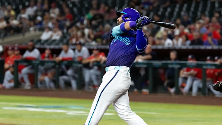 May 30, 2025; Phoenix, Arizona, USA; Arizona Diamondbacks third baseman Eugenio Suarez hits an RBI single in the first inning against the Washington Nationals at Chase Field. Mandatory Credit: Mark J. Rebilas-Imagn Images

