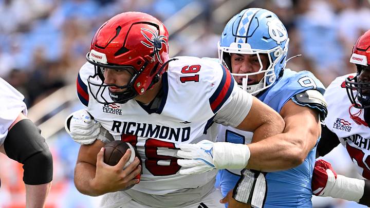 Sep 13, 2025; Chapel Hill, North Carolina, USA; North Carolina Tar Heels defensive lineman Melkart Abou-Jaoude (9) sacks Richmond Spiders quarterback Kyle Wickersham (16) in the first quarter at Kenan Stadium. Mandatory Credit: Bob Donnan-Imagn Images