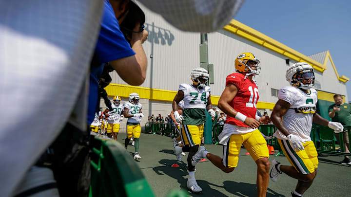 Green Bay Packers quarterback Jordan Love (10) runs onto the practice field for his first practice of training camp on Saturday, July 27, 2024, at Ray Nitschke Field in Ashwaubenon, Wis. 