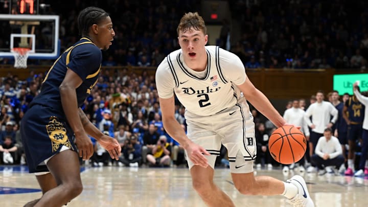 Jan 11, 2025; Durham, North Carolina, USA;  Duke Blue Devils forward Cooper Flagg (2) drives to the basket as Notre Dame Fighting Irish guard Markus Burton (3) defends during the first half at Cameron Indoor Stadium. Mandatory Credit: Rob Kinnan-Imagn Images