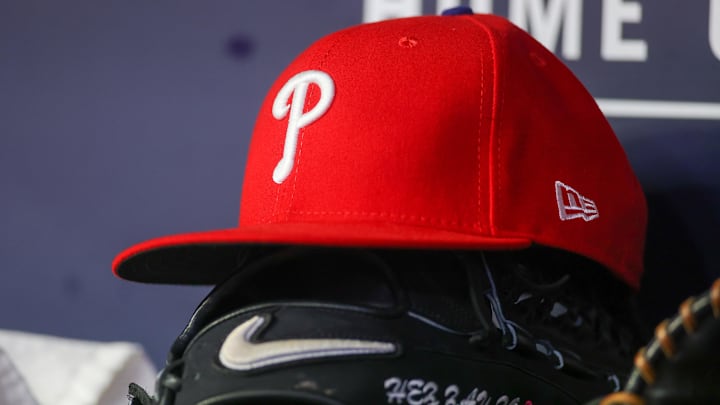 May 26, 2023; Atlanta, Georgia, USA; A detailed view of a Philadelphia Phillies hat and glove on the bench against the Atlanta Braves in the seventh inning at Truist Park. Mandatory Credit: Brett Davis-Imagn Images May 26, 2023; Atlanta, Georgia, USA; A detailed view of a Philadelphia Phillies hat and glove on the bench against the Atlanta Braves in the seventh inning at Truist Park. Mandatory Credit: Brett Davis-Imagn Images