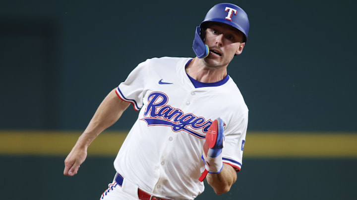 May 14, 2025; Arlington, Texas, USA;  Texas Rangers outfielder Evan Carter (32) rounds third base to score a run against the Colorado Rockies during the fifth inning at Globe Life Field