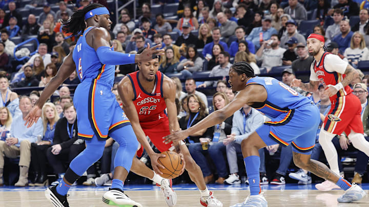 Feb 10, 2025; Oklahoma City, Oklahoma, USA; New Orleans Pelicans guard Trey Murphy III (25) drives between Oklahoma City Thunder guard Luguentz Dort (5) and forward Jalen Williams (8) during the second half at Paycom Center. Feb 10, 2025; Oklahoma City, Oklahoma, USA; New Orleans Pelicans guard Trey Murphy III (25) drives between Oklahoma City Thunder guard Luguentz Dort (5) and forward Jalen Williams (8) during the second half at Paycom Center.