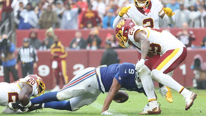 Oct 11, 2026; Landover, Maryland, USA; Washington Commanders safety Quan Martin (20) tackles New York Giants tight end Isaiah Likely (9) during overtime at Northwest Stadium. Oct 11, 2026; Landover, Maryland, USA; Washington Commanders safety Quan Martin (20) tackles New York Giants tight end Isaiah Likely (9) during overtime at Northwest Stadium.