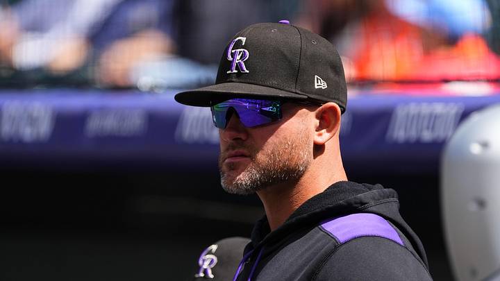 Colorado Rockies manager Warren Schaeffer (4) looks on from the dugout. 