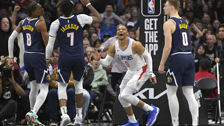 Apr 4, 2024; Los Angeles, California, USA; Los Angeles Clippers guard Russell Westbrook (0) dunks as Denver Nuggets guard PeytonWatson (8), guard Reggie Jackson (7) and guard Christian Braun (0) look on in the second half at Crypto.com Arena. Mandatory Credit: Jayne Kamin-Oncea-Imagn Images