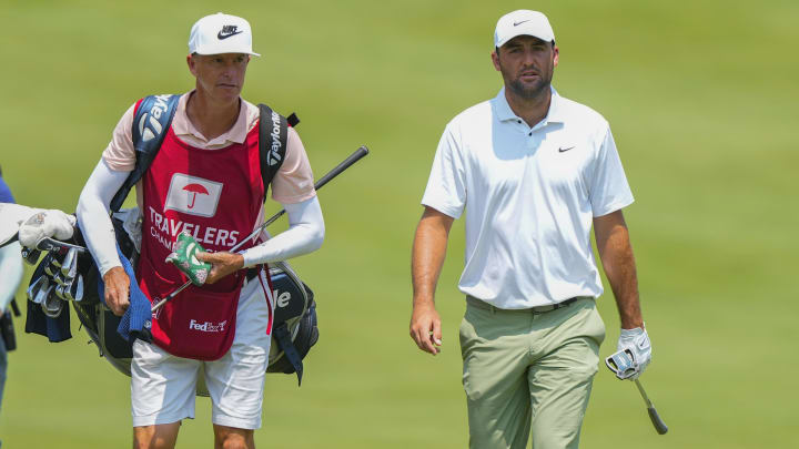 Jun 21, 2024; Cromwell, Connecticut, USA;Scottie Scheffler walks onto the first hole green with his caddie during the second round of the Travelers Championship golf tournament at TCP River Highlands. Mandatory Credit: Gregory Fisher-USA TODAY Sports