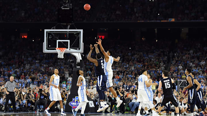 Apr 4, 2016; Houston, TX, USA; Villanova Wildcats forward Kris Jenkins (2) shoots the game-winning shot over North Carolina Tar Heels forward Isaiah Hicks (4) in the second half in the championship game of the 2016 NCAA Men's Final Four at NRG Stadium. Mandatory Credit: Robert Deutsch-Imagn Images