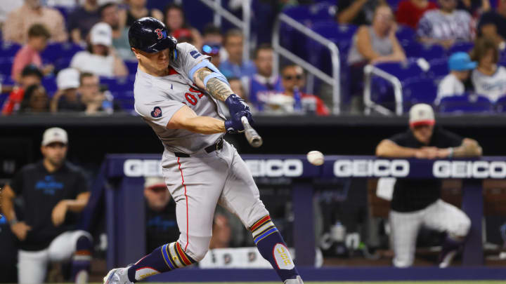 Jul 4, 2024; Miami, Florida, USA; Boston Red Sox left fielder Tyler O'Neill (17) hits an RBI single against the Miami Marlins during the eleventh inning at loanDepot Park. Mandatory Credit: Sam Navarro-USA TODAY Sports
