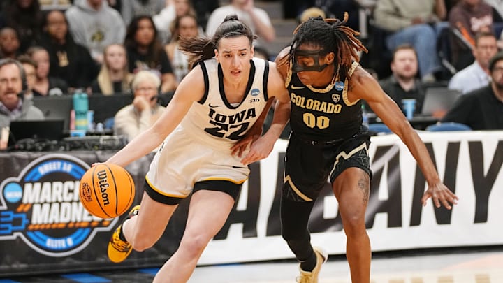 Iowa Hawkeyes guard Caitlin Clark (22) drives to the basket against Colorado Buffaloes guard Jaylyn Sherrod.