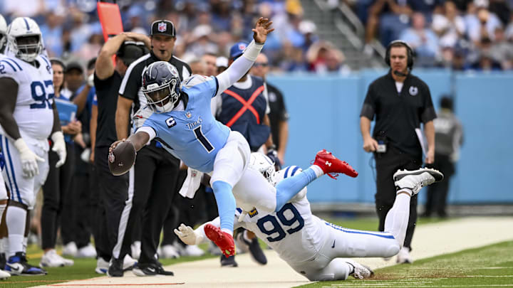 Sep 21, 2025; Nashville, Tennessee, USA; Indianapolis Colts defensive tackle Deforest Buckner (99) pushes Tennessee Titans quarterback Cam Ward (1) out of bounds during the second quarter at Nissan Stadium. Mandatory Credit: Steve Roberts-Imagn Images