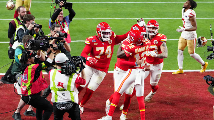 Mecole Hardman is mobbed by teammates after his game-winning touchdown catch won the Super Bowl in overtime after the 2023 season.