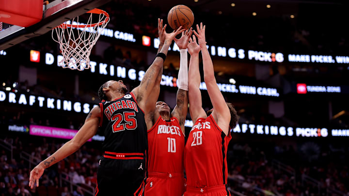 Mar 15, 2025; Houston, Texas, USA; Chicago Bulls forward Dalen Terry (25) battles Houston Rockets forward Jabari Smith Jr (10) and Houston Rockets center Alperen Sengun (28) for a rebound during the second quarter at Toyota Center. Mandatory Credit: Erik Williams-Imagn Images