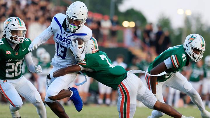 IMG Academy's Osani Gayles (13) gets tackled by Mandarin's Tamajh Mitchell (7) during their 2025 game in Jacksonville, Fla. IMG Academy's Osani Gayles (13) gets tackled by Mandarin's Tamajh Mitchell (7) during their 2025 game in Jacksonville, Fla.