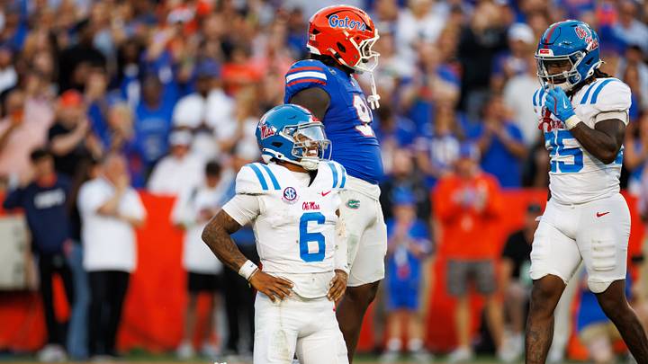Mississippi Rebels quarterback Trinidad Chambliss winces from the ground while Florida Gators defensive lineman Jeramiah McCloud (91) makes a gesture during the second half at Ben Hill Griffin Stadium. Mississippi Rebels quarterback Trinidad Chambliss winces from the ground while Florida Gators defensive lineman Jeramiah McCloud (91) makes a gesture during the second half at Ben Hill Griffin Stadium.