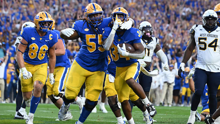 Sep 14, 2024; Pittsburgh, Pennsylvania, USA; Pittsburgh Panthers running back Derrick Davis Jr. (34) celebrates a touchdown with BJ Williams (55) as West Virginia Mountaineers defensive lineman Fatorma Mulbah (54) looks on during the fourth quarter at Acrisure Stadium. Mandatory Credit: Barry Reeger-Image Images Sep 14, 2024; Pittsburgh, Pennsylvania, USA; Pittsburgh Panthers running back Derrick Davis Jr. (34) celebrates a touchdown with BJ Williams (55) as West Virginia Mountaineers defensive lineman Fatorma Mulbah (54) looks on during the fourth quarter at Acrisure Stadium. Mandatory Credit: Barry Reeger-Image Images