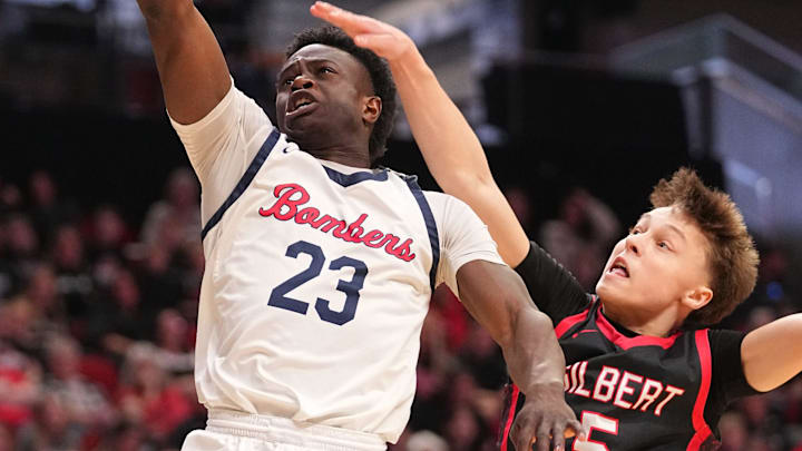 Jude Gibson of Ballard drives to the basket as Charlie Reich of Gilbert defends during a quarterfinal game of the boys state basketball tournament at the Casey's Center in Des Moines, March 9, 2026.
