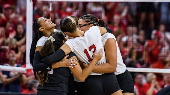 The Huskers celebrate winning the point after a long rally. 