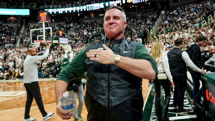 Michigan State's new football coach Pat Fitzgerald pats his heart at the crowd in attendance for the Spartans basketball game against Iowa on Tuesday, Dec. 2, 2025, at the Breslin Center in East Lansing.