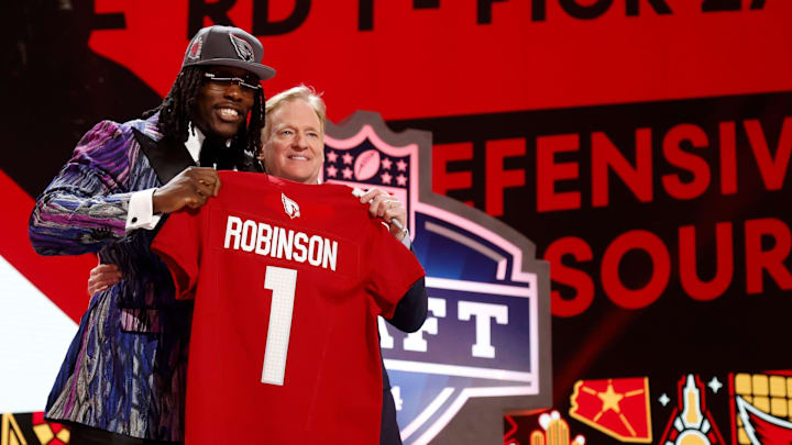 Missouri defensive lineman Darius Robinson greets NFL commissioner Roger Goodell and shows off his Arizona Cardinals jersey after he was picked in the first round of the 2024 NFL draft at the NFL draft theater in Detroit on Thursday, April 25, 2024.