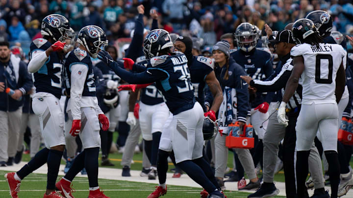 Tennessee Titans cornerback Elijah Molden (24) is mobbed after making a tackle to force a fourth