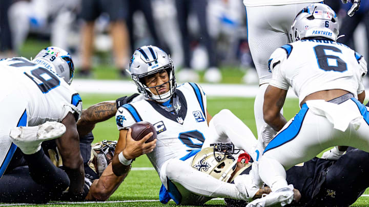 Sep 8, 2024; New Orleans, Louisiana, USA;  Carolina Panthers quarterback Bryce Young (9) is tackled as he scrambles out the pocket by New Orleans Saints cornerback Alontae Taylor (1) during the second half at Caesars Superdome. Mandatory Credit: Stephen Lew-Imagn Images