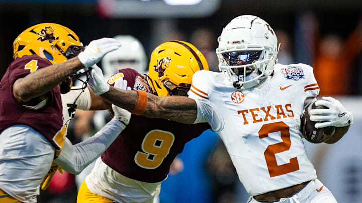 Texas Longhorns wide receiver Matthew Golden (2) grabs the facemark of Arizona State Sun Devils defensive back Myles Rowser (4) as he runs the ball in the first quarter as the Texas Longhorns play the Arizona State Sun Devils in the Peach Bowl College Football Playoff quarterfinal at Mercedes-Benz Stadium in Atlanta, Georgia, Jan. 1, 2025.