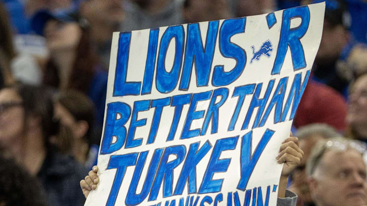 A young Detroit Lions fans holds up his sign in the second quarter against the Green Bay Packers during the annual Thanksgiving Day game at Ford Field. 