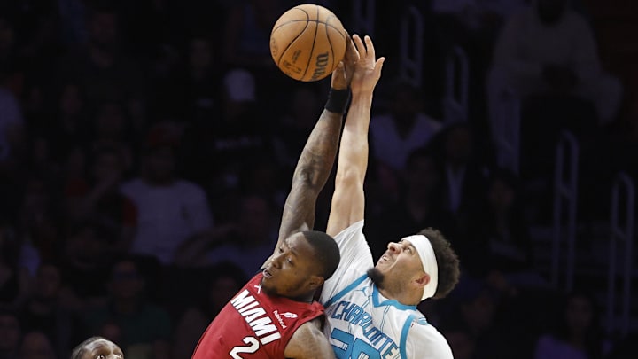 Mar 10, 2025; Miami, Florida, USA; Charlotte Hornets forward Moussa Diabate (14) watches guard Seth Curry (30) and Miami Heat guard Terry Rozier (2) jump for a rebound during the second half at Kaseya Center. Mandatory Credit: Rhona Wise-Imagn Images Mar 10, 2025; Miami, Florida, USA; Charlotte Hornets forward Moussa Diabate (14) watches guard Seth Curry (30) and Miami Heat guard Terry Rozier (2) jump for a rebound during the second half at Kaseya Center. Mandatory Credit: Rhona Wise-Imagn Images