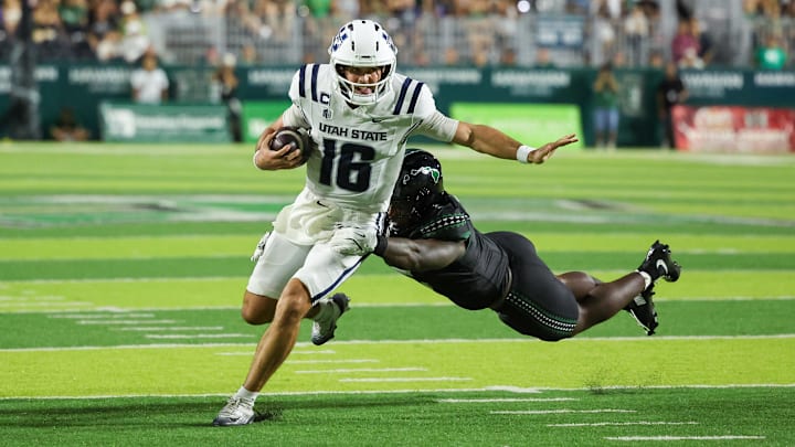 Oct 11, 2025; Honolulu, Hawaii, USA;  Hawaii Rainbow Warriors defensive lineman Tariq Jones (5) dives at Utah State Aggies quarterback Bryson Barnes (16) during the first half at Clarence T.C. Ching Athletics Complex. Mandatory Credit: Marco Garcia-Imagn Images