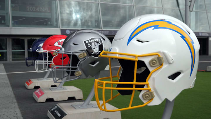 Oct 13, 2024; London, United Kingdom; Large helmets of the Los Angeles Chargers, Las Vegas Raiders, Kansas City Chiefs and Denver Broncos of the AFC West before an NFL International Series game at Tottenham Hotspur Stadium. Mandatory Credit: Kirby Lee-Imagn Images