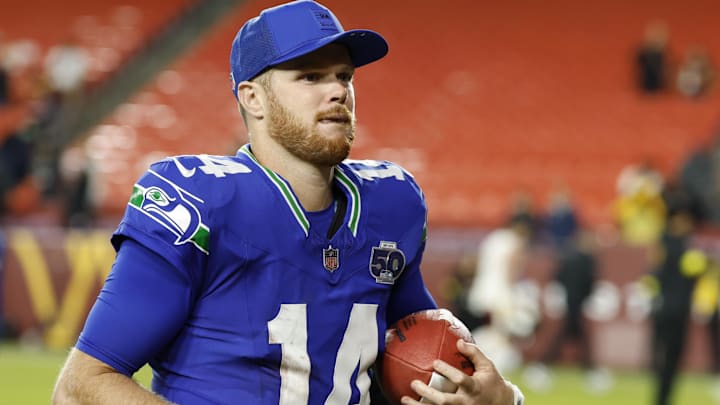 Seattle Seahawks quarterback Sam Darnold (14) leaves the field after the win against the Washington Commanders at Northwest Stadium. Seattle Seahawks quarterback Sam Darnold (14) leaves the field after the win against the Washington Commanders at Northwest Stadium.