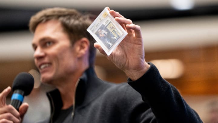 Tom Brady holds a card at American Dream for the grand opening of Card Vault by Tom Brady, a sports card and memorabilia retailer, East Rutherford, Friday, Apr. 11, 2025. Tom Brady holds a card at American Dream for the grand opening of Card Vault by Tom Brady, a sports card and memorabilia retailer, East Rutherford, Friday, Apr. 11, 2025.