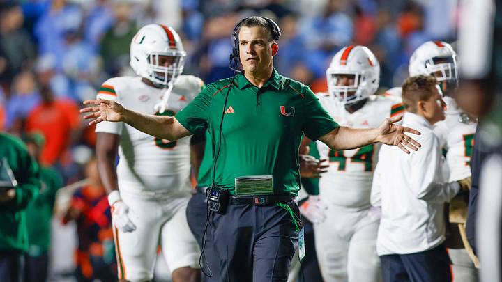 Oct 14, 2023; Chapel Hill, North Carolina, USA; Miami Hurricanes head coach Mario Cristobal stands on the field during a timeout as the Hurricanes play against the North Carolina Tar Heels in the second half at Kenan Memorial Stadium. Mandatory Credit: Nell Redmond-USA TODAY Sports