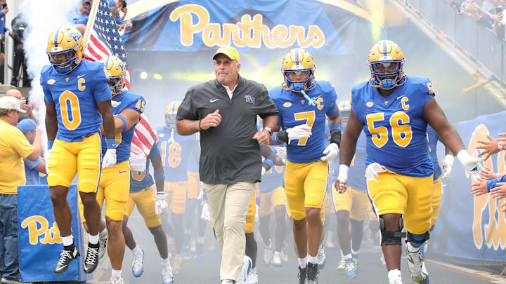 Sep 6, 2025; Pittsburgh, Pennsylvania, USA;  Pittsburgh Panthers running back Desmond Reid (0), head coach Pat Narduzzi, defensive back Javon McIntyre (7) and offensive lineman Lyndon Cooper (56) lead the Panthers onto the field to play the Central Michigan Chippewas  at Acrisure Stadium. Mandatory Credit: Charles LeClaire-Imagn Images
