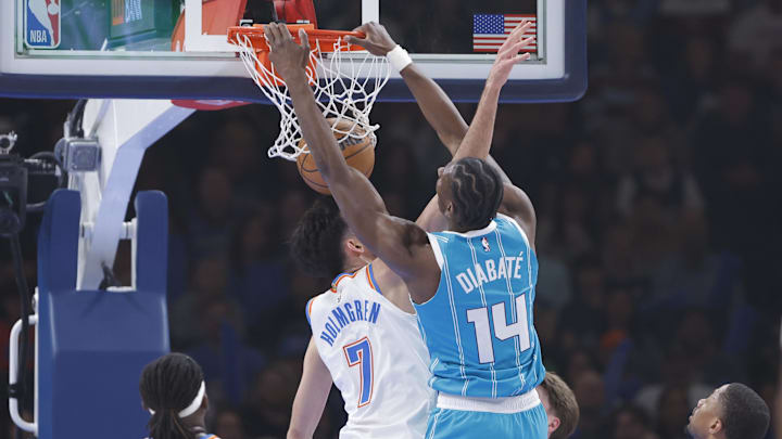 Jan 5, 2026; Oklahoma City, Oklahoma, USA; Charlotte Hornets forward Moussa Diabate (14) dunks over Oklahoma City Thunder center Chet Holmgren (7) during the first quarter at Paycom Center. Mandatory Credit: Alonzo Adams-Imagn Images