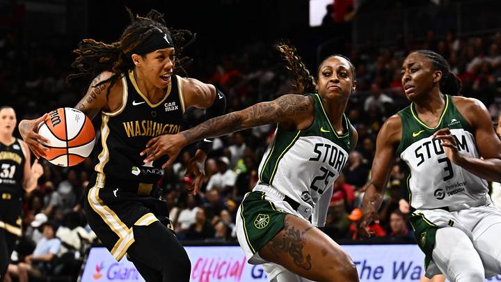 Jul 26, 2025; Washington, District of Columbia, USA;  Washington Mystics guard Sug Sutton (1) drives to the basket as Seattle Storm guard Tiffany Mitchell (25) and forward Nneka Ogwumike (3) defend during the third quarter at CareFirst Arena. 