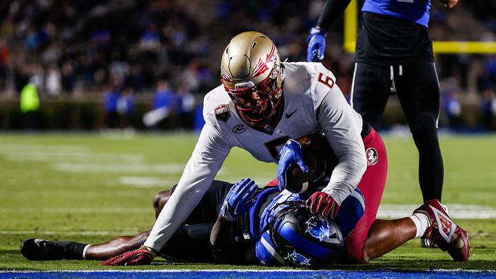 Oct 18, 2024; Durham, North Carolina, USA; Duke Blue Devils quarterback Maalik Murphy (6) attempts to run the ball to the end zone but is tacked by Florida State Seminoles defensive lineman Darrell Jackson Jr. (6) during the first half of the game at Wallace Wade Stadium. Mandatory Credit: Jaylynn Nash-Imagn Images Oct 18, 2024; Durham, North Carolina, USA; Duke Blue Devils quarterback Maalik Murphy (6) attempts to run the ball to the end zone but is tacked by Florida State Seminoles defensive lineman Darrell Jackson Jr. (6) during the first half of the game at Wallace Wade Stadium. Mandatory Credit: Jaylynn Nash-Imagn Images