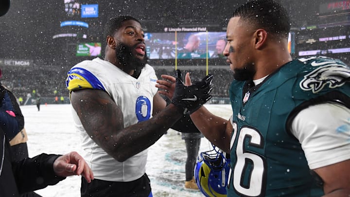 Jan 19, 2025; Philadelphia, Pennsylvania, USA; Los Angeles Rams linebacker Jared Verse (8) greets Philadelphia Eagles running back Saquon Barkley (26) after their 2025 NFC divisional round game at Lincoln Financial Field. Mandatory Credit: Eric Hartline-Imagn Images