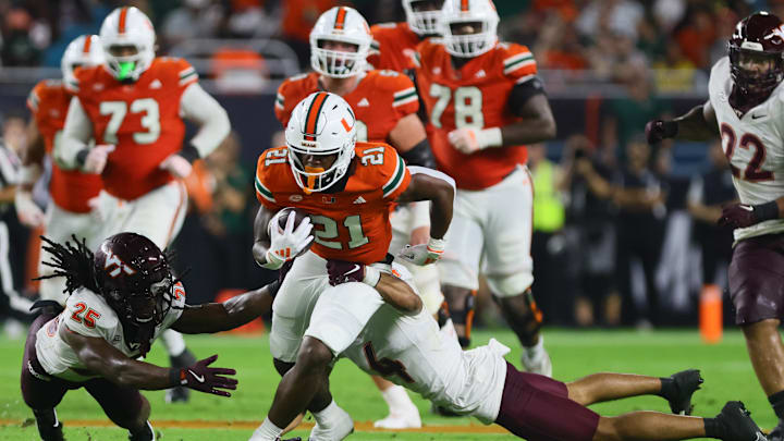 Sep 27, 2024; Miami Gardens, Florida, USA; Miami Hurricanes running back Jordan Lyle (21) runs with the football past Virginia Tech Hokies cornerback Mansoor Delane (4) during the second quarter Hard Rock Stadium. Mandatory Credit: Sam Navarro-Imagn Images Sep 27, 2024; Miami Gardens, Florida, USA; Miami Hurricanes running back Jordan Lyle (21) runs with the football past Virginia Tech Hokies cornerback Mansoor Delane (4) during the second quarter Hard Rock Stadium. Mandatory Credit: Sam Navarro-Imagn Images