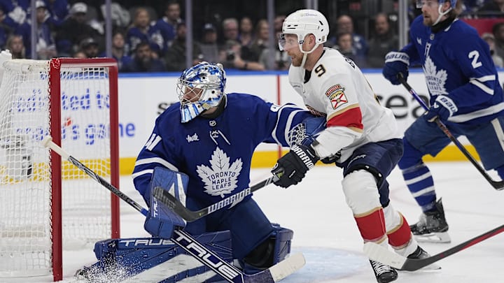 Toronto Maple Leafs goaltender Anthony Stolarz and Florida Panthers forward Sam Bennett battle for position in front of the goal.