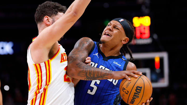 Georges Niang #20 of the Atlanta Hawks defends Paolo Banchero #5 of the Orlando Magic.