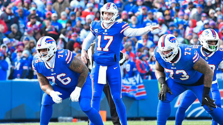 Buffalo Bills quarterback Josh Allen and Dion Dawkins at the line of scrimmage.