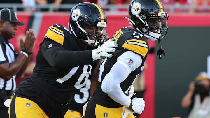 Pittsburgh Steelers wide receiver George Pickens (14) celebrates with guard James Daniels (78) after scoring a touchdown against the Tampa Bay Buccaneers during the first quarter at Raymond James Stadium.