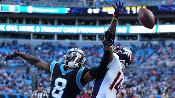 Nov 27, 2022; Charlotte, North Carolina, USA;  Carolina Panthers cornerback Jaycee Horn (8) breaks up a pass intended for Denver Broncos wide receiver Courtland Sutton (14) in the fourth quarter at Bank of America Stadium. 