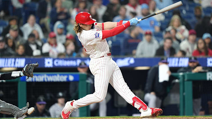 Philadelphia Phillies infielder Alec Bohm (28) hits an RBI double against the Colorado Rockies.