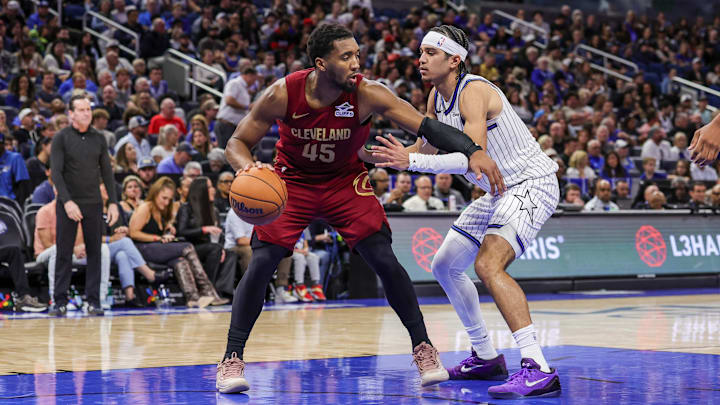 Jan 24, 2026; Orlando, Florida, USA; Cleveland Cavaliers guard Donovan Mitchell (45) handles the ball in front of Orlando Magic guard Anthony Black (0) during the second quarter at Kia Center. Mandatory Credit: Mike Watters-Imagn Images