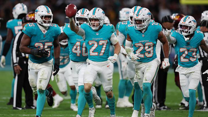 Miami Dolphins cornerback Ethan Bonner (27) celebrates with teammates against the Washington Commanders in the 2025 NFL Madrid Game at Santiago Bernabeu Stadium.