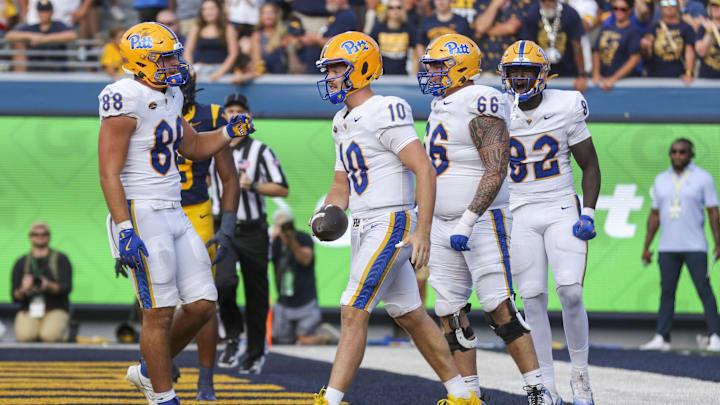 Sep 13, 2025; Morgantown, West Virginia, USA; Pittsburgh Panthers quarterback Eli Holstein (10) celebrates after running for a touchdown during the third quarter against the West Virginia Mountaineers at Milan Puskar Stadium. Mandatory Credit: Ben Queen-Imagn Images